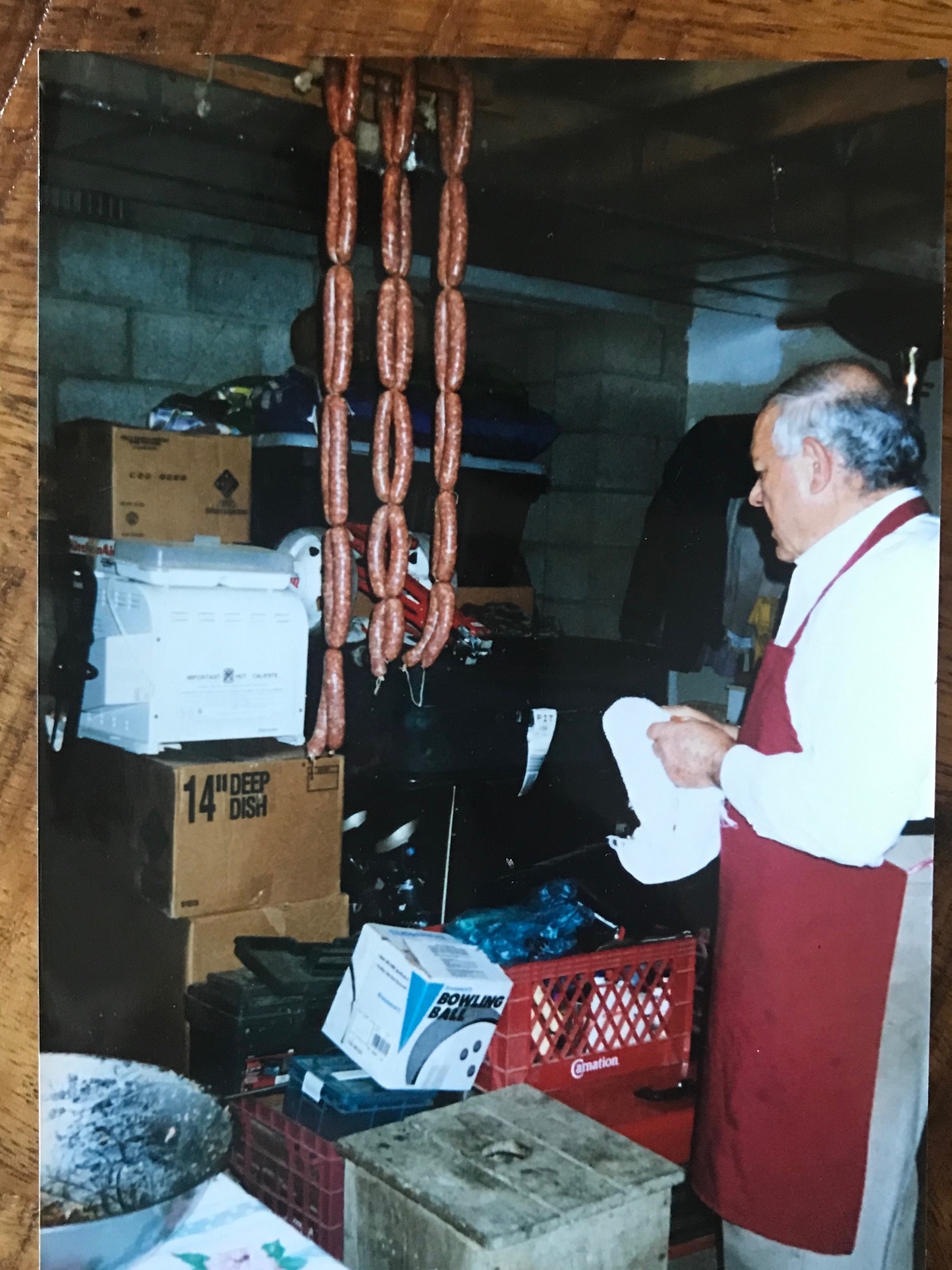 Romualdo Magnelli curing strings of homemade sausage